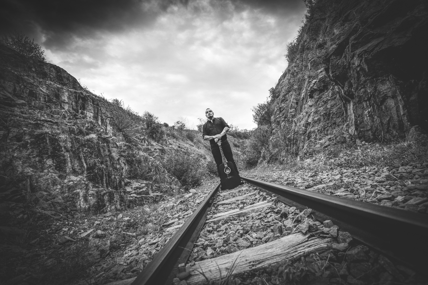 Silhouette au bord des rails dans un paysage rocheux